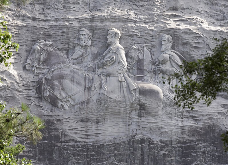
              FILE - This Tuesday, June 23, 2015 file photo shows a carving depicting confederates Stonewall Jackson, Robert E. Lee and Jefferson Davis, in Stone Mountain, Ga. The park is readying its “Fantastic Fourth Celebration” Thursday through Sunday, and multiple Confederate flag varieties are still displayed at the mountain’s base. Officials are considering what to do about those flags, says Bill Stephens, chief executive officer of the Stone Mountain Memorial Association. (AP Photo/John Bazemore, File)
            