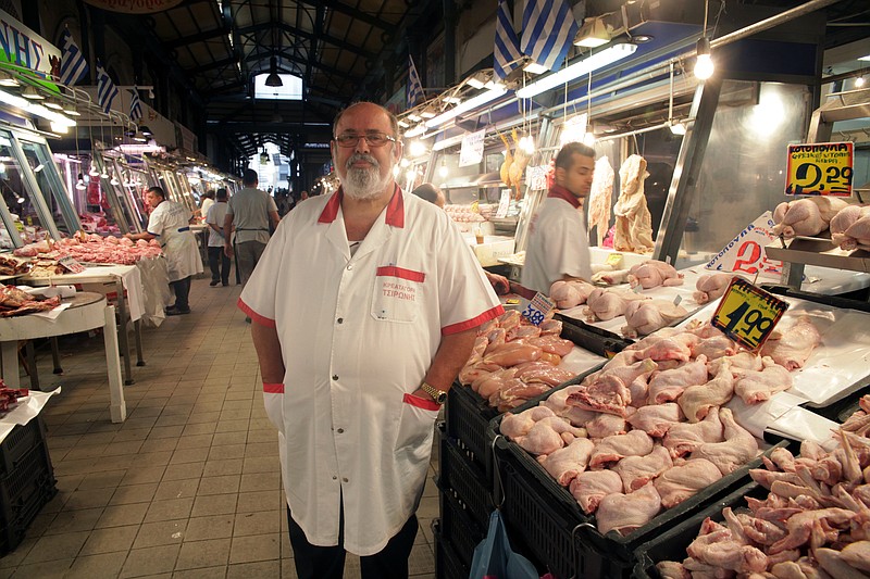 
              Stall owner Kleanthis Tsironis poses at Varvakios Market in Athens, Tuesday, June 30, 2015. On the streets of the Greek capital, resplendent in the early days of summer, there’s still a veneer of normalcy - at least for foreigners. But for locals, the miserly 60 euros ($67) per day cash limit at ATMs makes it difficult to run a small business or keep a family going. (AP Photo/Spyros Tsakiris)
            