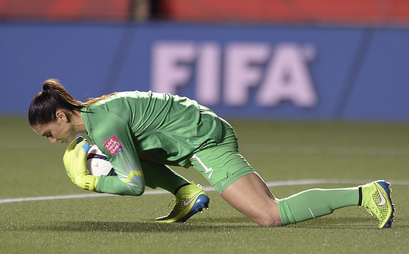 U.S. keeper Hope Solo covers the ball after making a save against China during the second half of a quarterfinal match in the FIFA Women's World Cup soccer tournament Friday, June 26, 2015, in Ottawa, Ontario, Canada.