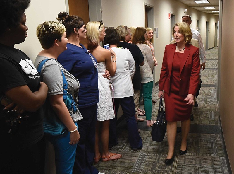 Staff Photo by Tim BarberFlora Tydings passes students waiting for their grades as she tours the Chattanooga State Health Science Center during her visit in May to interview for the job of president of the school.