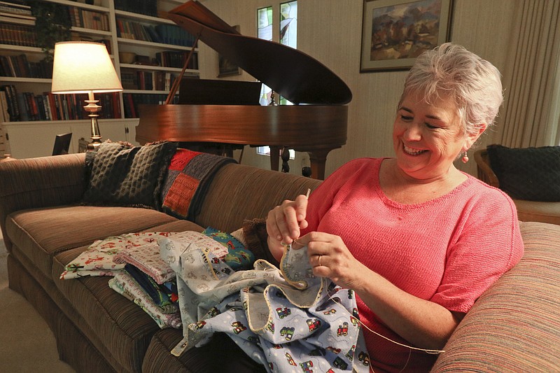 Staff Photo by Dan Henry. Nancy Hall crochets baby blankets to sell on her MyParadeDesigns storefront on Etsy.