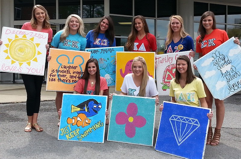 Contributed PhotoSorority women from the University of Tennesse at Chattanooga show some of the handpainted ceiling tiles donated to T.C. Thompson Children's Hospital at Erlanger. 
