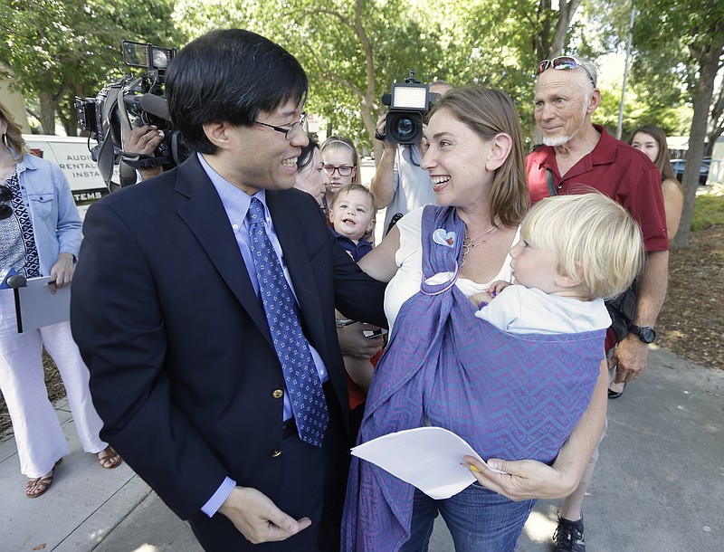 The Associated PressCalifornia state Sen. Richard Pan, one of the sponsors of California's new tough vaccination law, is thanked by Leah Russin, who holds her 21-month-old son, Leo, after Gov. Jerry Brown signed the legislation Tuesday.