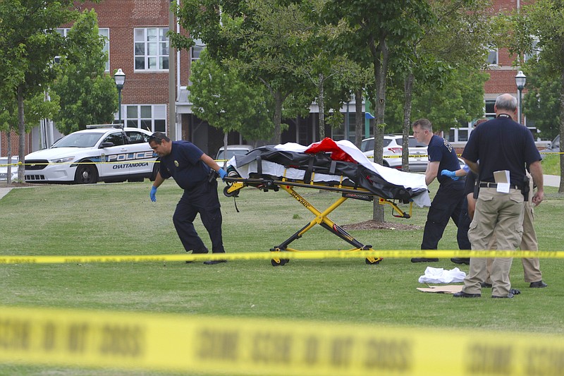 Emergency personnel transport a body while working the scene of a suicide at Renaissance Park in North Chattanooga.