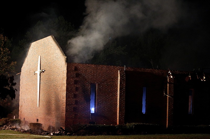 
              Smoke rises from Mount Zion African Methodist Episcopal church late Tuesday, June 30, 2015, in Greeleyville, S.C., which caught fire Tuesday. The African-American church that was burned down by the Ku Klux Klan in 1995 caught fire again Tuesday night. (Veasey Conway/The Morning News via AP)
            