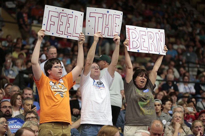 
              From left, Sam Brueggeman, 16, and his parents Bill and Carol, of North Freedom, Wis., lead a cheer while waiting for Democratic presidential candidate Sen. Bernie Sanders to arrive at the Veterans Memorial Coliseum at Alliant Energy Center in Madison, Wis., Wednesday, July 1, 2015. (Michael P. King/Wisconsin State Journal via AP)
            