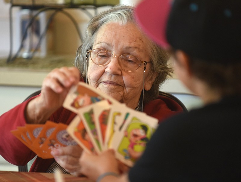 Staff Photo by Angela Lewis Foster
Naydeen Parsons draws a card from Rachel Angelin Thursday at The Lantern of Morning Pointe of Collegedale. Kids from the Collegedale Adventist Youth in Action 2015 service program visited the facility to play games and entertain residents.