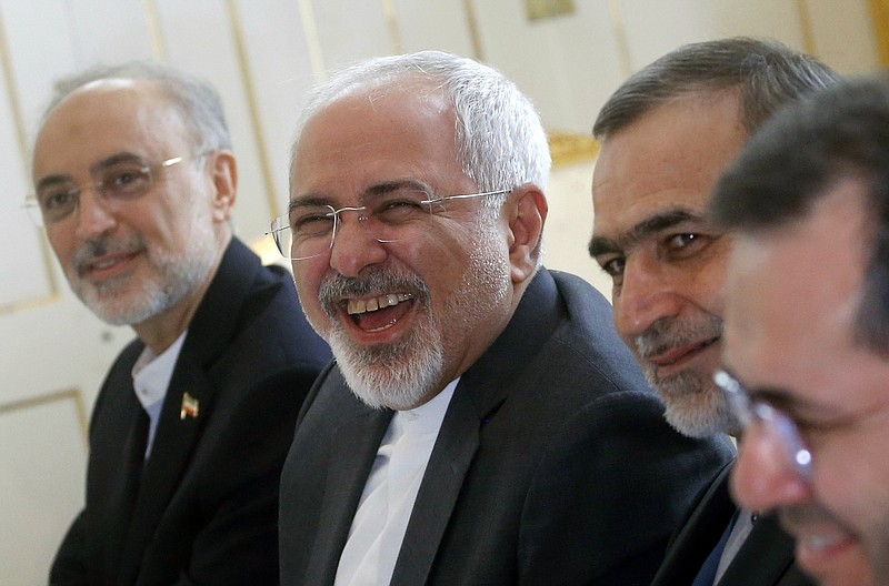 Iranian Foreign Minister Javad Zarif laughs during a meeting with U.S. Secretary of State John Kerry at a hotel in Vienna, Austria, last Tuesday. Pushing past a deadline, world powers and Iran extended negotiations for a comprehensive nuclear agreement.