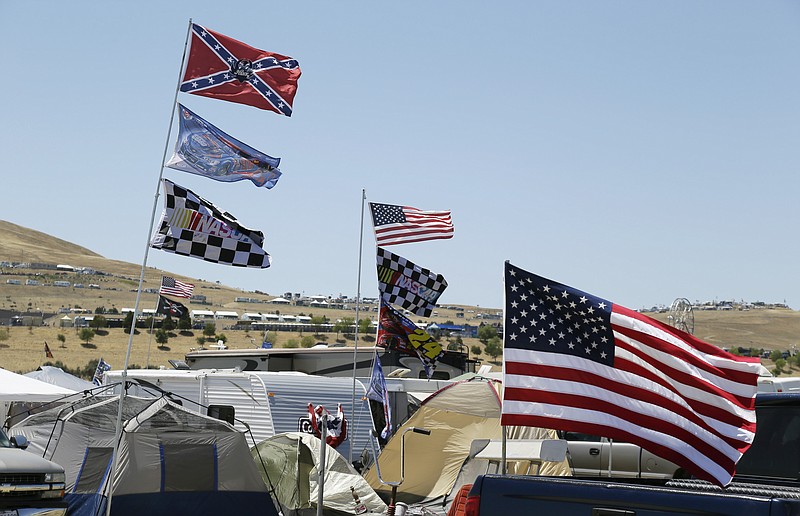 
              A number of flags, including a Confederate themed one,  fly atop RV's in a campground outside the track during practice for the NASCAR Sprint Cup Series auto race Friday, June 26, 2015, in Sonoma, Calif. (AP Photo/Eric Risberg)
            