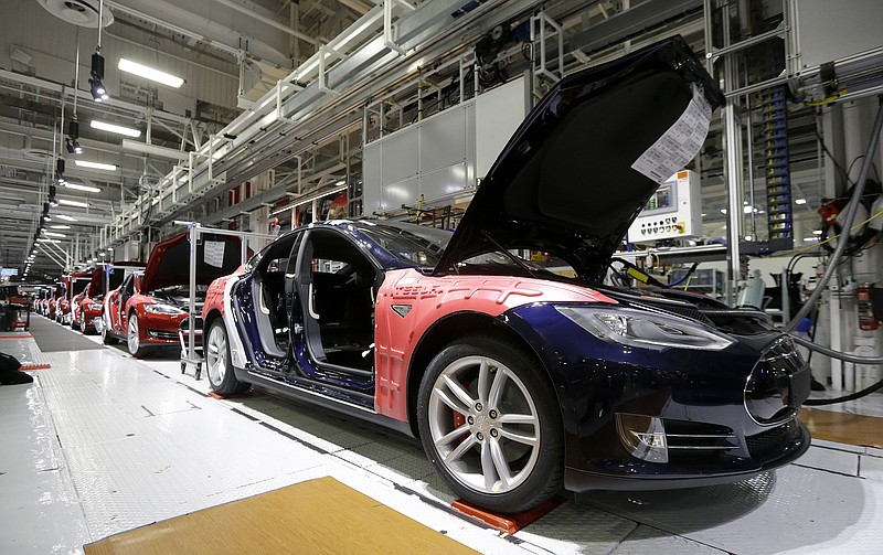 
              FILE - In this May 14, 2015, file photo, Tesla Model S cars are shown in the Tesla factory in Fremont, Calif. Tesla’s second-quarter deliveries surged 52 percent to set a company record exceeding 11,000 vehicles, the electric car maker said Thursday, July 2, 2015. (AP Photo/Jeff Chiu, File)
            