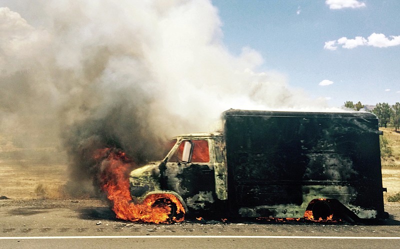 Smoke rises from a burning truck packed with fireworks after it exploded on Interstate 15 near Ivanpah, Calif., close to the Nevada state line Thursday, July 2, 2015, in this photo provided by Jay Rutherford.