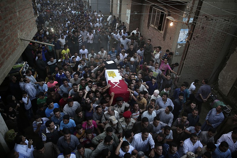 Egyptians carry the coffin of 1st Lt. Mohammed Adel Abdel Azeem, killed in Wednesday's attack by Islamic militants in the Sinai, during the funeral procession at his home village Tant Al Jazeera in Qalubiyah, north of Cairo, Egypt, Thursday, July 2, 2015. 