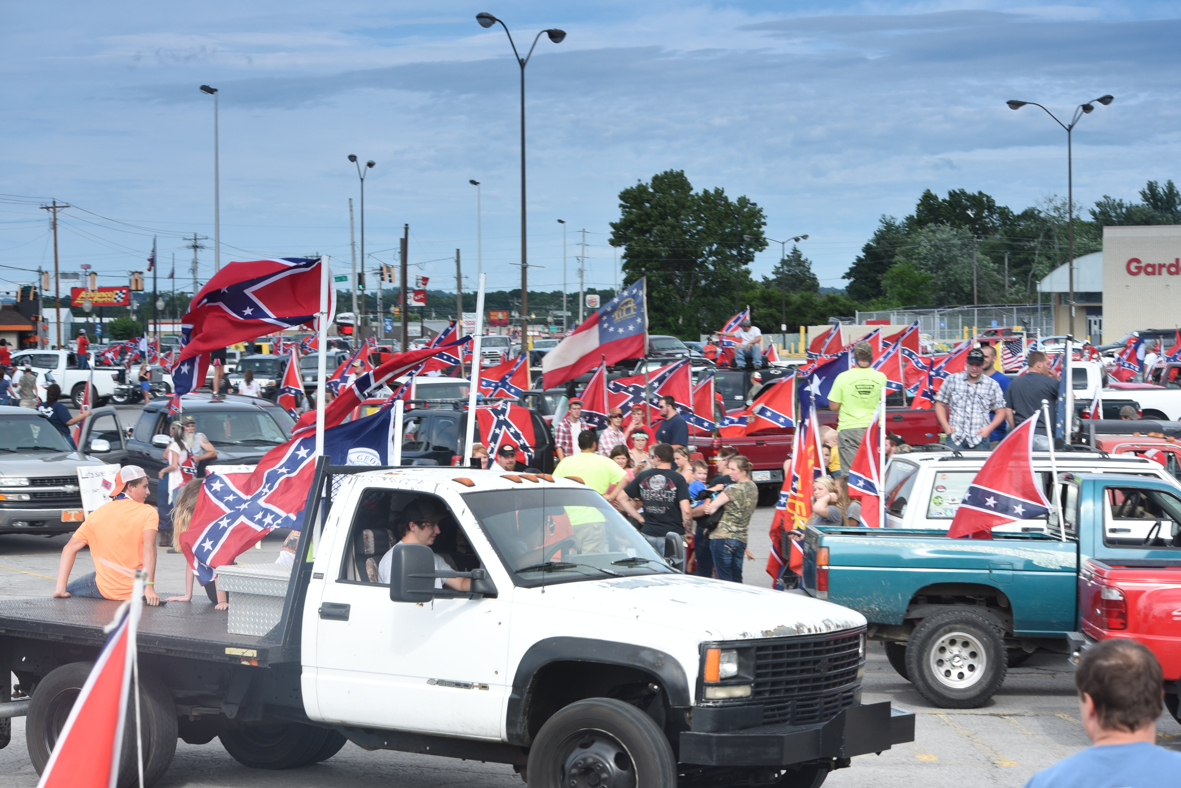 Staff photo by Tim Barber
Dozens of people gather in a Fort Oglethorpe parking lot as a caravan of vehicles came from Tennessee flying the Confederate flags late Friday afternoon. The beginning of the parade of colors began in the Gunbarrel Wal-Mart parking lot in East Brainerd.