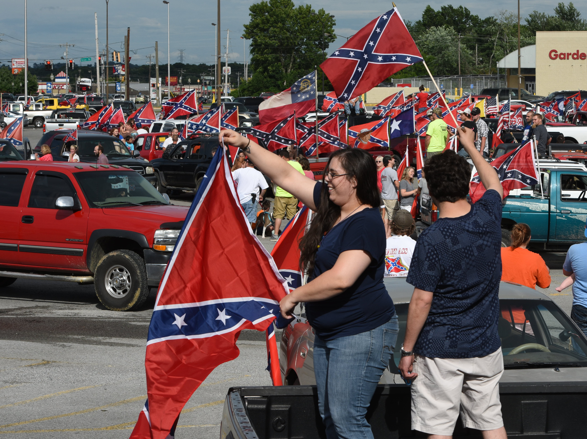 Staff photo by Tim Barber
Claudia Barra, left, and Carlos Luna, fly their Confederate flags in a sea of red, white and blue, stars and bars Friday evening in the Fort Oglethorpe. The two are U.S. Navy Veterans who served at NAS Lemoore, California from 2004 to 2007, according to Barra. Luna drove from Chicago to visit his friend and attend the rally of flags.