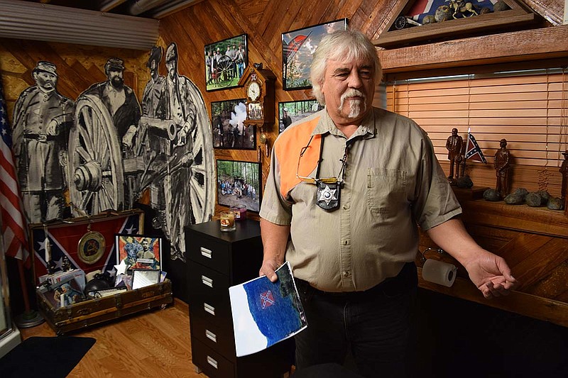 Staff Photo by Ben Benton/Chattanooga Times Free Press 
July 1, 2015 Dunlap, Tenn., resident Carson Camp, who also is a local constable and former town mayor, talks about plans to erect a giant Confederate flag monument on his property on the slopes of Fredonia Mountain, overlooking the town. Here, he stands in a room at his home filled with Confederate memorabilia.