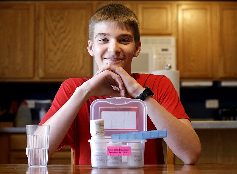 
              In this photo taken Wednesday, May 13, 2015, Hayden Murphy, 13, sits for a photo with his medicine at his home in Plainfield, Ill. Hayden is among more than 400 children and adults participating in U.S. government-funded international research investigating whether experimental insulin capsules can prevent or at least delay Type 1 diabetes. To enroll, participants must first get bad news: results of a blood test showing their chances for developing the disease are high. (AP Photo/Nam Y. Huh)
            