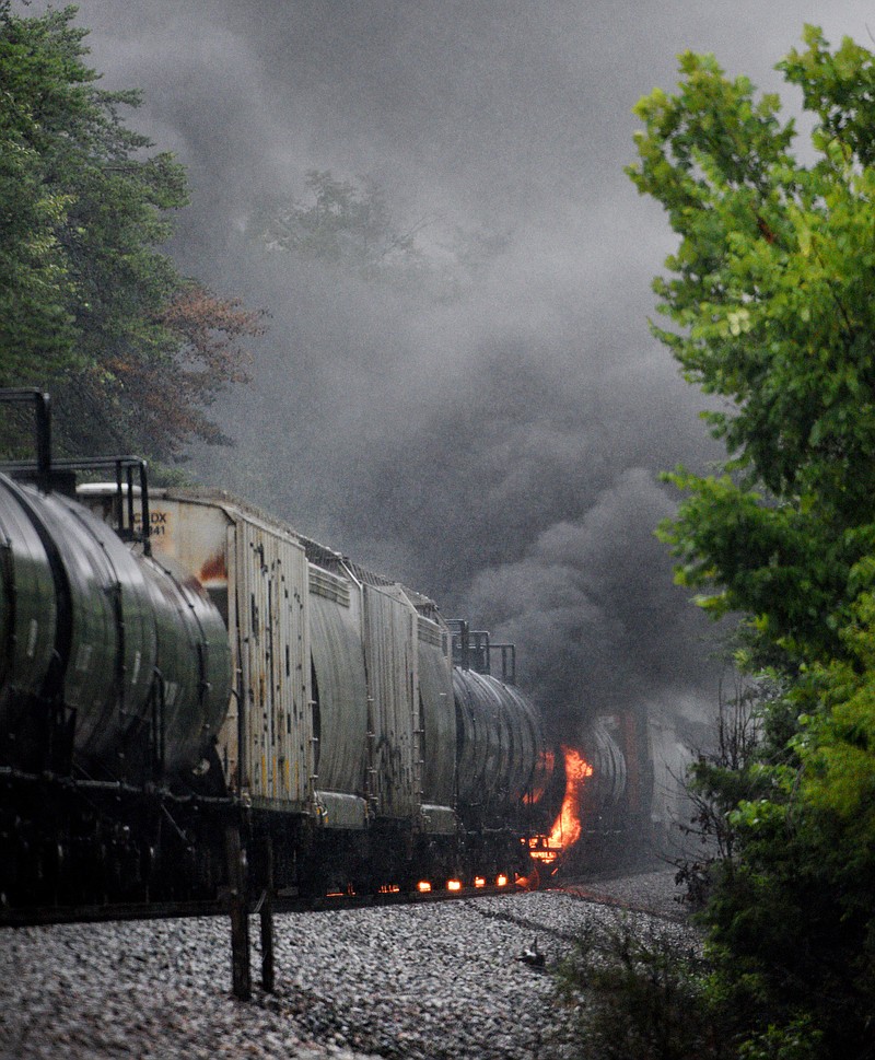 
              Smoke rises from a CSX train following the derailment of a train car, Thursday, July 2, 2015, in Maryville, Tenn. The derailment of the car, carrying a flammable and toxic substance, caused the evacuation of thousands in the surrounding area. (Michael Patrick/Knoxville News Sentinel via AP)
            
