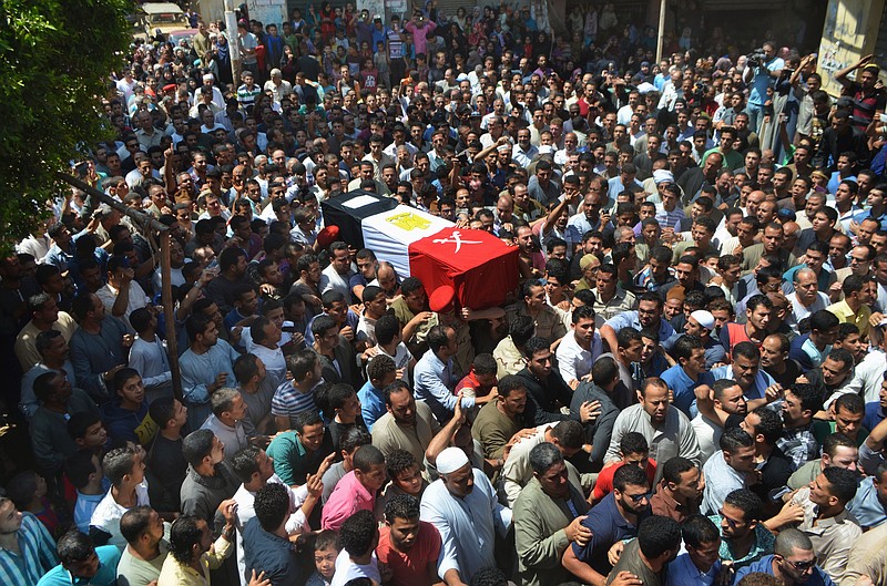 
              FILE - In this Thursday, July 2, 2015, file photo, people carry the coffin for 1st Lt. Mohammed Ashraf, killed in Wednesday's attack by Islamic militants in the Sinai, during the funeral procession in Ashmoun, north of Cairo, Egypt. When Abdel-Fattah el-Sissi  led the army’s overthrow of Egypt’s Islamist president two years ago, he promised to usher in new stability for the country. Instead, now President el-Sissi is facing an even tougher challenge: An Islamic militant insurgency that unleashed its worst violence yet the past week. (AP Photo/Ashour Abosalm, File)
            