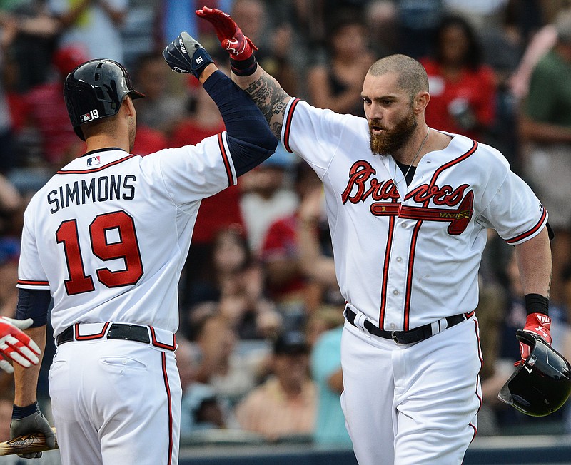 Atlanta Braves left fielder Jonny Gomes is greeted by teammate Andrelton Simmons (19) after hitting a home run in their game against the Philadelphia Phillies Friday, July 3, 2015, in Atlanta. 