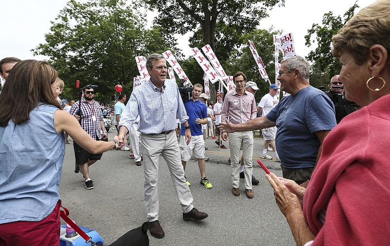 
              Republican presidential candidate former Florida Gov. Jeb Bush, center, shakes hands while participating in the Fourth of July Parade in Amherst, N.H., Saturday, July 4, 2015. (AP Photo/Cheryl Senter)
            