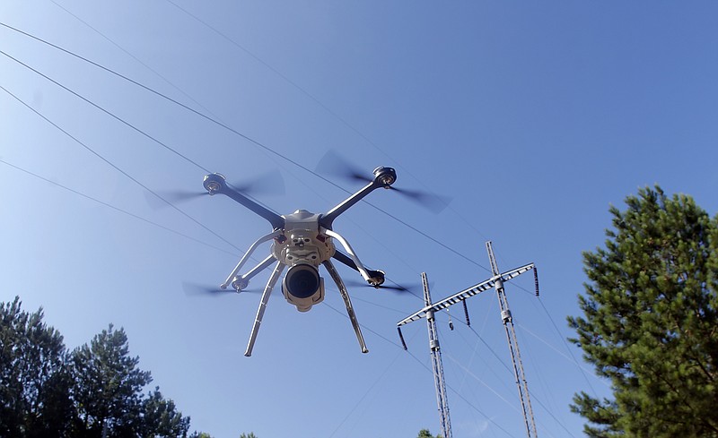 This June 22, 2015 photo shows a drone lifting off at a Georgia Power training complex during power line inspection demonstration in Lithonia, Ga. Power companies across the United States are testing whether drones as small as 10 pounds can spot trouble on transmission lines or inspect equipment deep inside hard-to-reach power plant boilers. (AP Photo/John Bazemore)
            