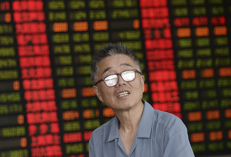 
              A stock investor looks up in a brokerage house in Shanghai Friday July 3, 2015.  China cut the number of initial public offerings planned this month by two-thirds on Friday, adding to frantic efforts to shore up plunging stock prices following another 5.7 percent decline in the country's main market index. (Chinatopix Via AP) CHINA OUT
            