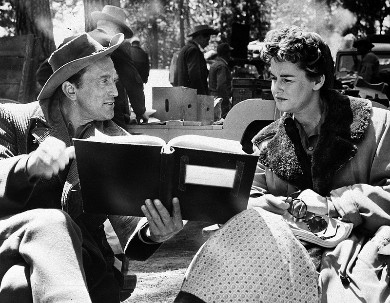 In this june 8, 1955 file photo, actor Kirk Douglas and his former wife, Diana Douglas, go over their lines for a scene in "The Indian Fighter," being made on location near Bend, Ore. Diana Douglas, the first wife of Kirk Douglas and mother of Michael Douglas, has died in Los Angeles. She was 92. 