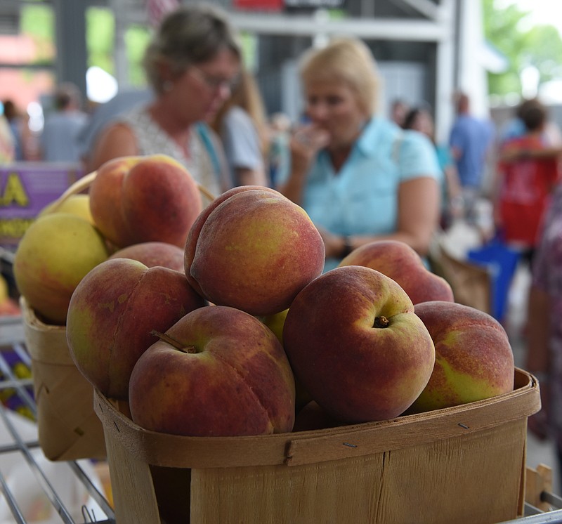 Staff photo by John Rawlston/Chattanooga Times Free Press 
Teresa Horton, left, and Kathy Hannah look at a display from Watsonia Peaches from Monetta, S. C., during the annual Peach Festival at the Chattanooga Market on Sunday, July 5, 2015, in Chattanooga, Tenn. 