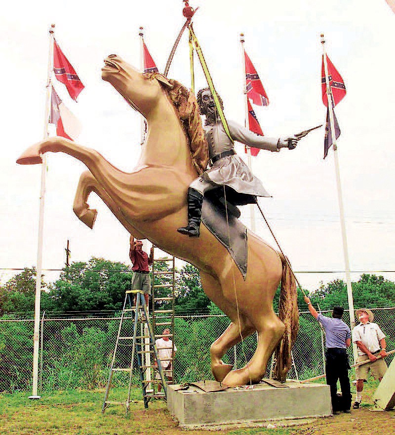 FILE -- In this 1998 file photo, a statue of Confederate Gen. Nathan Bedford Forrest is put up on private property along Interstate 65 in Nashville, Tenn. The statue is one of several of Forrest, an early leader of the Ku Klux Klan, that have come under question after a massacre at a black church in Charleston, S.C. Following the massacre, a bipartisan mix of officials across the country is calling for the removal of Confederate flags and other symbols of the Confederacy from public places. (AP Photo/Mark Humphrey, File)