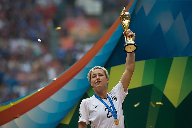 
              United States' Abby Wambach hoists the trophy after defeating Japan to win the FIFA Women's World Cup soccer championship in Vancouver, British Columbia, Canada, Sunday, July 5, 2015.   (Darryl Dyck/The Canadian Press via AP) MANDATORY CREDIT
            