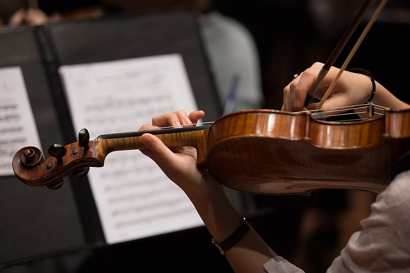 
              In this Feb. 20, 2014 photo, a member of the Memphis Symphony Orchestra plays the violin during a rehearsal in Memphis, Tenn. After acknowledging a financial strain, the symphony saw the result of turnaround efforts and support from the public with a strong 2014-15 season. (Andrew J. Breig/Daily News via AP)
            