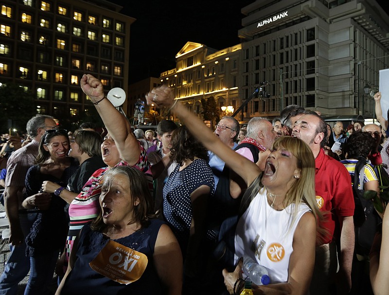 Supporters of the No vote react after the first results of the referendum at Klafthmonos square in Athens, Sunday, July 5, 2015. Greece faced an uncharted future as officials counted the results of a referendum Sunday on whether to accept creditors' demands for more austerity in exchange for rescue loans, with three opinion polls showing a tight race with a narrow victory likely for the "no" side. (AP Photo/Petr David Josek)