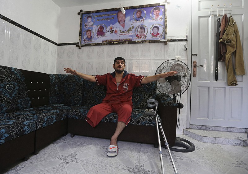 
              In this Saturday, June 27, 2015 photo, Mohammed al-Selek, 39, gives an interview to The Associated Press at his family house in the Shijaiyah neighborhood of Gaza City, northern Gaza Strip. Al-Selek's life changed forever last July 30, when Israeli mortar shells slammed into his home in an overcrowded Gaza neighborhood, killing all his three children, his father and six other relatives. A year later, al-Selek, who  lost his leg during the airstrike, still struggles to recover and come to terms with his family's loss in the 50-day Israel-Hamas war. (AP Photo/Adel Hana)
            