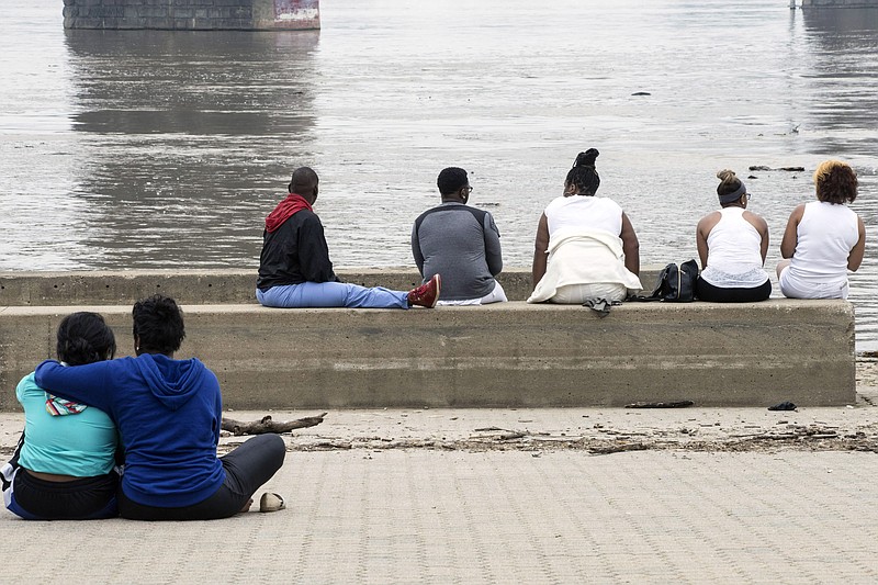 
              People gather on the wharf under the Second Street Bridge in Louisville, Ky., Sunday, July 5, 2015, awaiting new information after a boating accident on the Ohio River. Authorities say at least three people were killed and multiple people are missing after a boat they were riding in hit the Clark Memorial Bridge and capsized in to the river on Saturday night. (Marty Pearl/The Courier-Journal via AP)
            