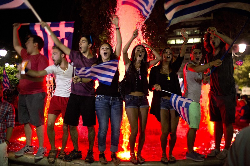 
              Supporters of the No vote celebrate after the results of the referendum at Syntagma square in Athens, Sunday, July 5, 2015. Greeks overwhelmingly rejected creditors' demands for more austerity in return for rescue loans in a critical referendum Sunday, backing Prime Minister Alexis Tsipras, who insisted the vote would give him a stronger hand to reach a better deal. (AP Photo/Emilio Morenatti)
            