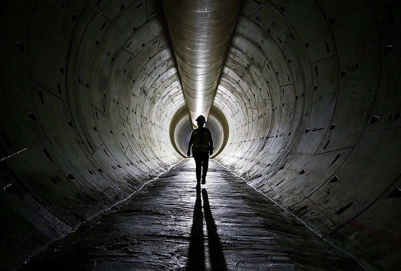 
              In this June 1, 2015 photo, Robin Rockey of the Southern Nevada Water Authority walks through a tunnel still under construction beneath Lake Mead near Boulder City, Nev. When operational, the three-mile-long tunnel and intake will allow the Southern Nevada Water Authority to draw water from Lake Mead even if its water level falls below the two current intakes. (AP Photo/John Locher)
            