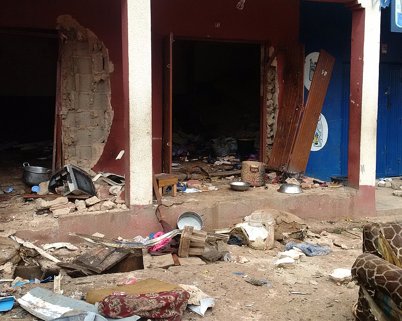 
              In this photo taken on a mobile phone, debris lays strewn over the area after a bomb exploded at a mosque in Jos, Nigeria, Monday, July 6, 2015. Two bombs blamed on the Islamic extremist group Boko Haram exploded at a crowded mosque and a Muslim restaurant in Nigeria's central city of Jos, killing 51 people, officials said Monday. (AP Photo)
            