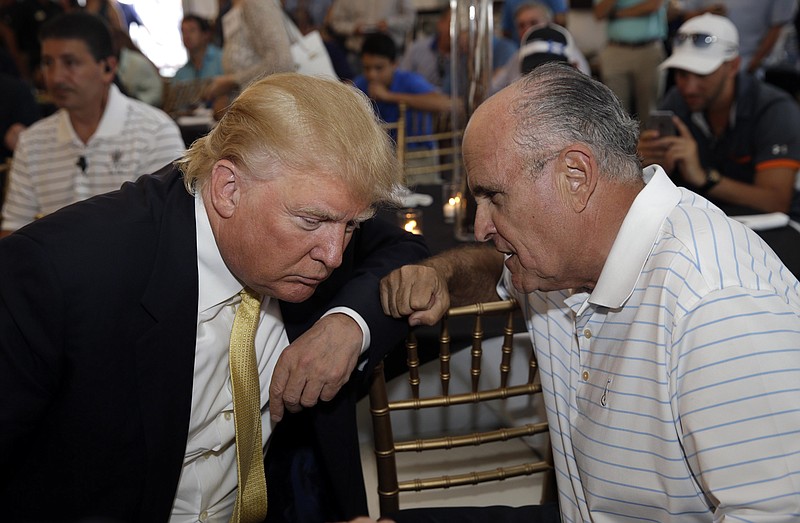 Republican presidential candidate Donald Trump, left, talks the former New York City mayor Rudy Giuliani at a fundraising event in the Bronx borough of New York, Monday, July 6, 2015.