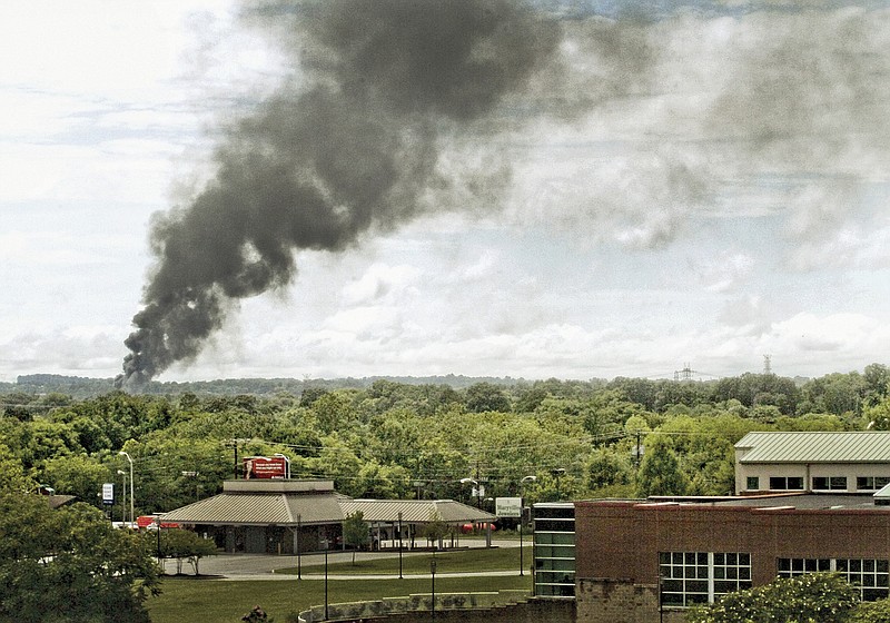 Smoke rises into sky Thursday, July 2, 2015, from train derailment in Maryville, Tenn. Officials say an evacuation is expected to last at least until Friday, after a CSX train car carrying a flammable and toxic substance derailed and caught fire. They also asked nearby residents not to drink well water for now. About 5,000 people in the area were evacuated along with several businesses. (Mark A Large/The Daily Times via AP)