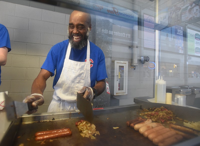 Staff Photo by Angela Lewis Foster/ The Chattanooga Times Free Press- 6/17/15
Marcus Sales laughs with a co-worker while cooking at AT&T Field before the game Wednesday between the Chattanooga Lookouts and the Jacksonville Suns.
