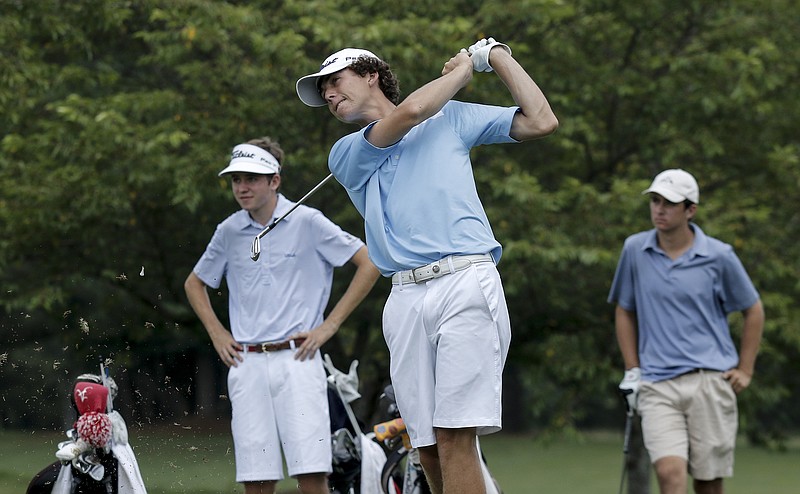 Davis Shore, left, and Chase Harris, right, watch as Scott Stevens tees off on the 17th hole during the first round of the Tennessee Junior Amateur tournament Tuesday, July 7, 2015, at Cleveland Golf and Country Club in Cleveland, Tenn.