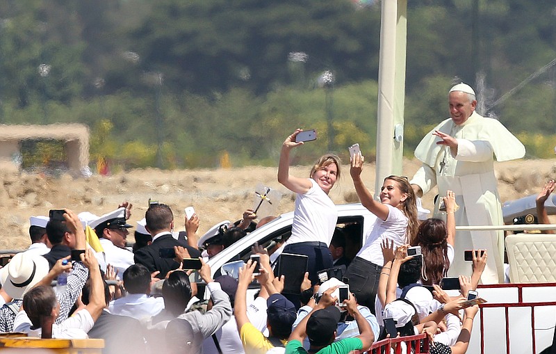 
              Pope Francis waves to the crowd as he rides in the popemobile through Samanes Park, where he will celebrate Mass, in Guayaquil, Ecuador, Monday, July 6, 2015. A crowd estimated at 1 million people, greeted Francis on the packed dirt of Samanes Park for a late-morning Mass. (AP Photo/Fernando Vergara)
            