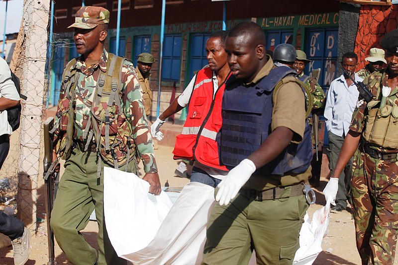 
              Kenya Police officers carry a body in Mandera, Kenya, Tuesday, July 7, 2015. At least 14 people were killed in an attack early Tuesday in the country's north by al-Shabab, Islamic extremist rebels from neighboring Somalia, a Kenyan official said. Eleven people were also wounded in the attack which took place in Soko Mbuzi village in Mandera County near Kenya's border with Somalia, said Mandera County Commissioner Alex Nkoyo. (AP Photo)
            