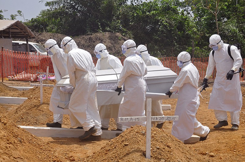 
              FILE - In this Wednesday, March 11, 2015 file photo, health workers carry a body of a person that they suspected died form the Ebola virus at a new graveyard on the outskirts of Monrovia, Liberia. A panel commissioned by the World Health Organization to assess its bungled response to the world’s biggest Ebola outbreak said the crisis exposed the agency’s “organizational failings” and called for WHO to be held accountable. But the report failed to identify any individuals responsible for the failures, instead blaming WHO’s bureaucratic culture. In its final report issued on Tuesday, July 7, 2015 the panel said WHO’s sluggish efforts to contain Ebola were partly explained by “a hope that the crisis could be managed by good diplomacy.” (AP Photo/ Abbas Dulleh,File)
            