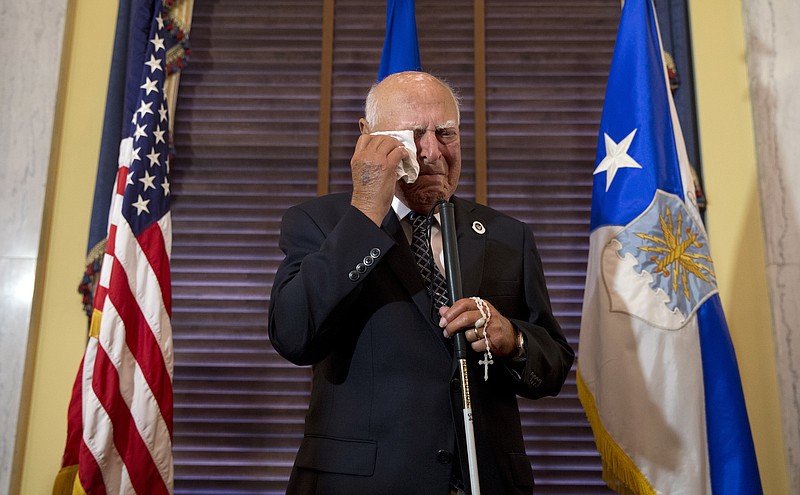 
              Retired U.S. Air Force 2nd Lt., John R. Pedevillano, 93, of College Park, Md., wipes tears from his eyes after Senate Armed Services Committee Chairman Sen. John McCain, R-Ariz., and Vice Chief of Staff of the U.S. Air Force, Gen. Larry Spencer, honored him with the Presidential Unit Citation with one Oak Leaf Cluster during a ceremony on Capitol Hill in Washington, Tuesday, July 7, 2015. Pedevillano served in the U.S. Army Air Corps as the youngest bombardier in the 306th Bomb Group, flew six combat missions and survived being shot down by Nazi fighter pilots. (AP Photo/Carolyn Kaster)
            