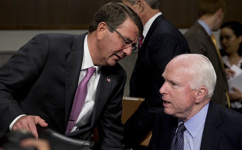 Defense Secretary Ash Carter leans into Senate Armed Services Committee Chairman Sen. John McCain, R-Ariz., as they speak before the start of the Senate Armed Services Committee hearing on Capitol Hill in Washington, Tuesday, July 7, about Counter-ISIL (Islamic State of Iraq and the Levant) Strategy.