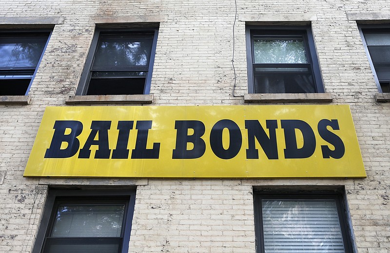 In this photo taken Tuesday, July 7, 2015, a bail bonds sign hangs on the side of a bail bonds business near Brooklyn's courthouse complex and jail in New York. (AP Photo/Kathy Willens)
            