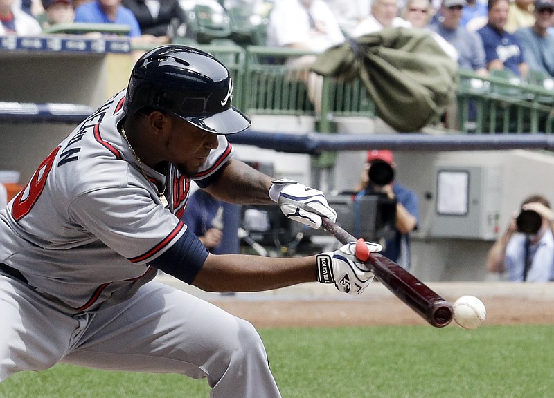 Atlanta Braves pitcher Julio Teheran bunts during the third inning of Wednesday's game against the Brewers in Milwaukee.