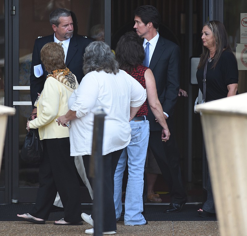 Former Murray County Magistrate Bryant Cochran, facing camera at left, exits the Federal Courthouse in Rome, Ga., with supporters and his attorney Page Pate after a sentencing hearing on Wednesday, July 7, 2015.