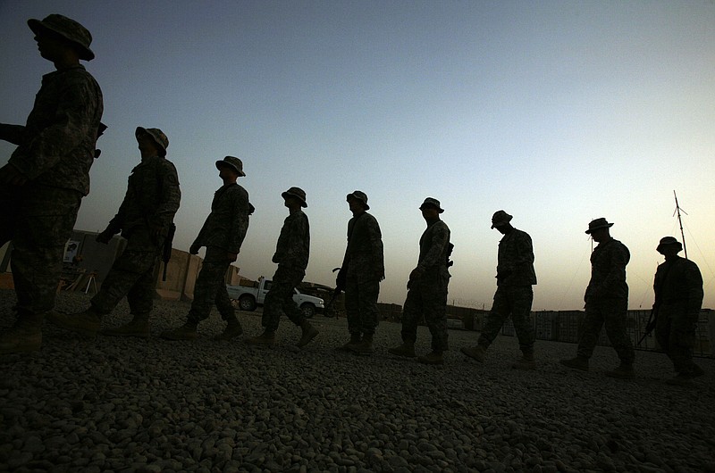 
              FILE - In this June 29, 2009 file photo, U.S. Army soldiers walk in a line at a reenlistment ceremony for a comrade in Baqouba, Iraq. New research published Wednesday, July 8, 2015 in JAMA Psychiatry shows war-time suicide attempts in the Army are most common in early-career enlisted soldiers who have not been deployed, while officers are less likely to try to end their lives. The study looked at data on nearly 1,000 suicide attempts among almost 1 million active-duty Army members during the wars in Afghanistan and Iraq, from 2004 to 2009. (AP Photo/Maya Alleruzzo, File)
            